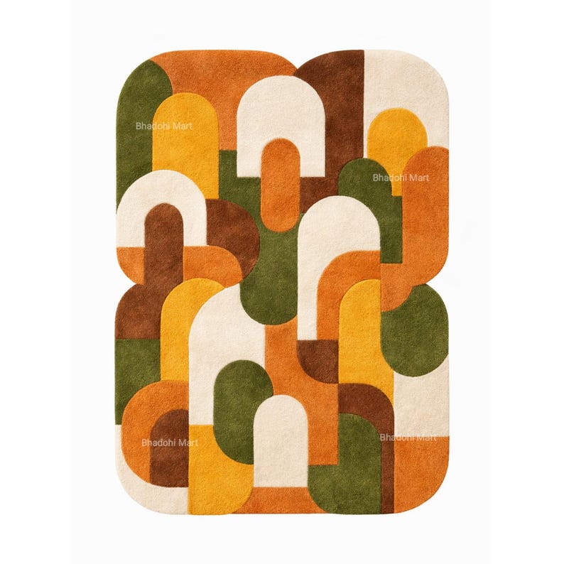 May include: A rectangular rug with a geometric pattern in shades of orange, brown, green, yellow, and cream. The design features rounded shapes and arches. The text "Bhadohi Mart" is visible in several places on the rug.