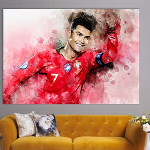 May include: A watercolor painting of a soccer player wearing a red jersey with the number 7 on it. The player is giving a thumbs up and smiling. The background is a pink and white watercolor wash.
