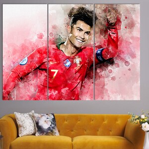 May include: A watercolor painting of a soccer player in a red jersey with the number 7 on the front. The player is giving a thumbs up and smiling. The background is a watercolor wash of pink and white.