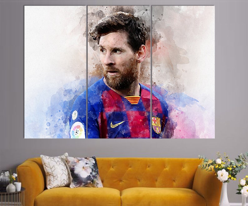 May include: A watercolor painting of a soccer player wearing a blue and red jersey with a white Nike swoosh logo. The player has a beard and is looking to the left. The background is a watercolor wash of blue, pink, and white.