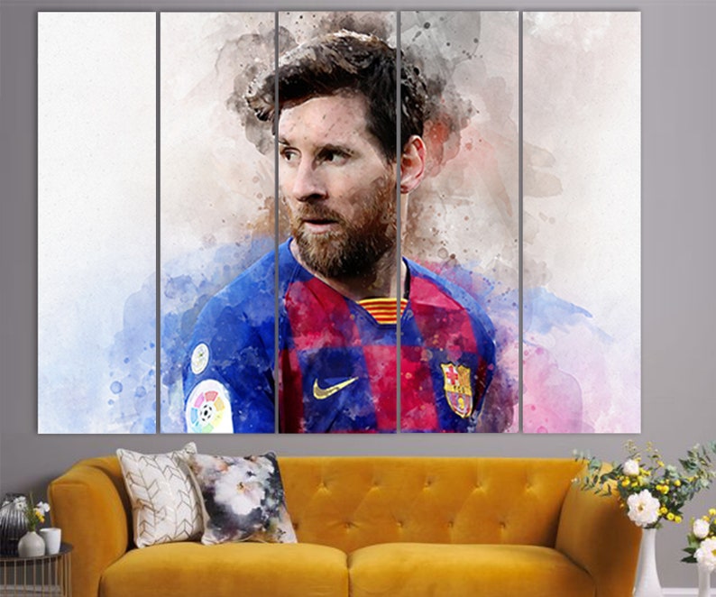 May include: A watercolor painting of a soccer player wearing a blue and red jersey with a white Nike swoosh logo. The player has a beard and is looking to the side. The background is a blurred watercolor wash of pink and blue.