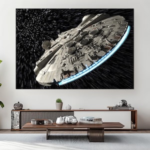 May include: A large canvas print of the Millennium Falcon starship in space. The ship is detailed with various panels and circular features, with a blue glowing edge. The background is a black space with streaks of white light.