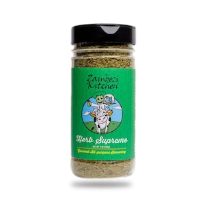 May include: A clear plastic spice jar with a black lid, filled with green herbs. The label is green with the text "Zambezi Kitchen" and "Herb Supreme." A cartoon cow and chef are also on the label. The jar contains 5 oz (148g) of gourmet all-purpose seasoning.