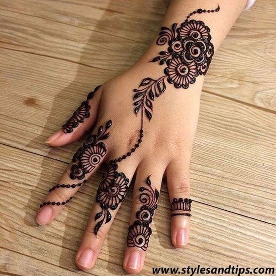 Swooshes and Delicious Dots using a mehndi/henna cone. Credit to