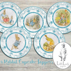 May include: Five round blue and white paper cupcake toppers featuring illustrations from the children's book "Peter Rabbit". The toppers feature Peter Rabbit, a robin, and a family of rabbits.