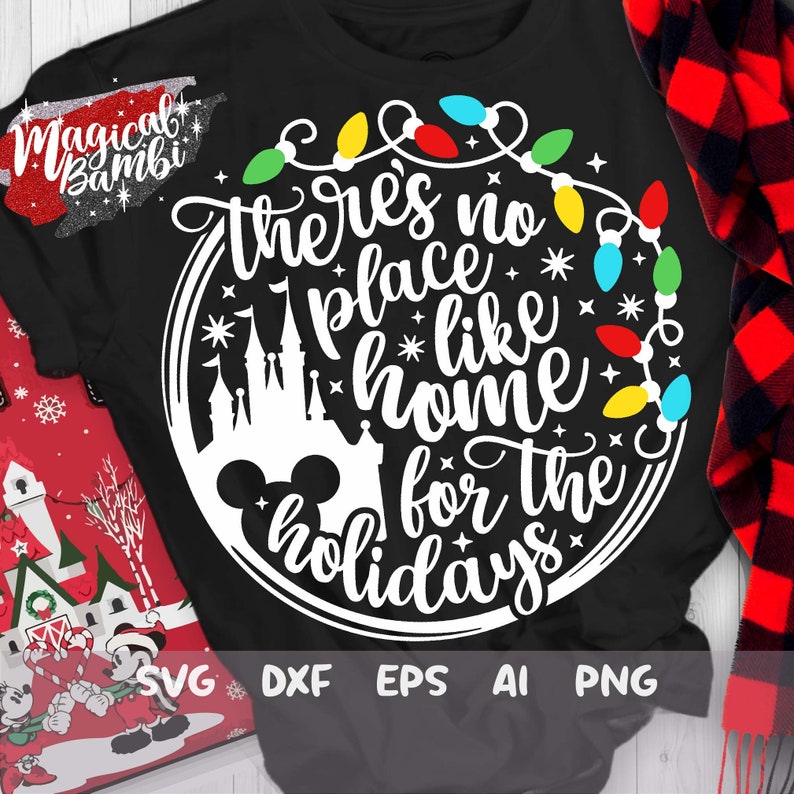 May include: A black t-shirt with a white circle design featuring a Mickey Mouse head, a silhouette of Cinderella's castle, and the text "there's no place like home for the holidays" surrounded by a string of colorful Christmas lights.