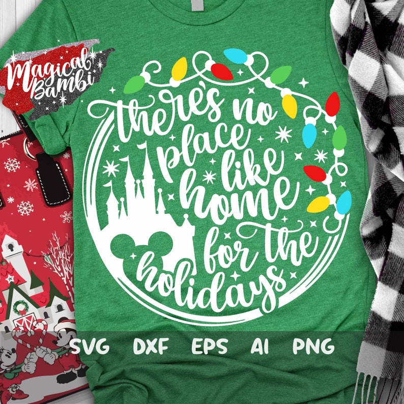 May include: Green t-shirt with a white design that says "There's no place like home for the holidays". The design also includes a silhouette of Cinderella's castle and Mickey Mouse ears. The design is surrounded by a string of colorful Christmas lights.