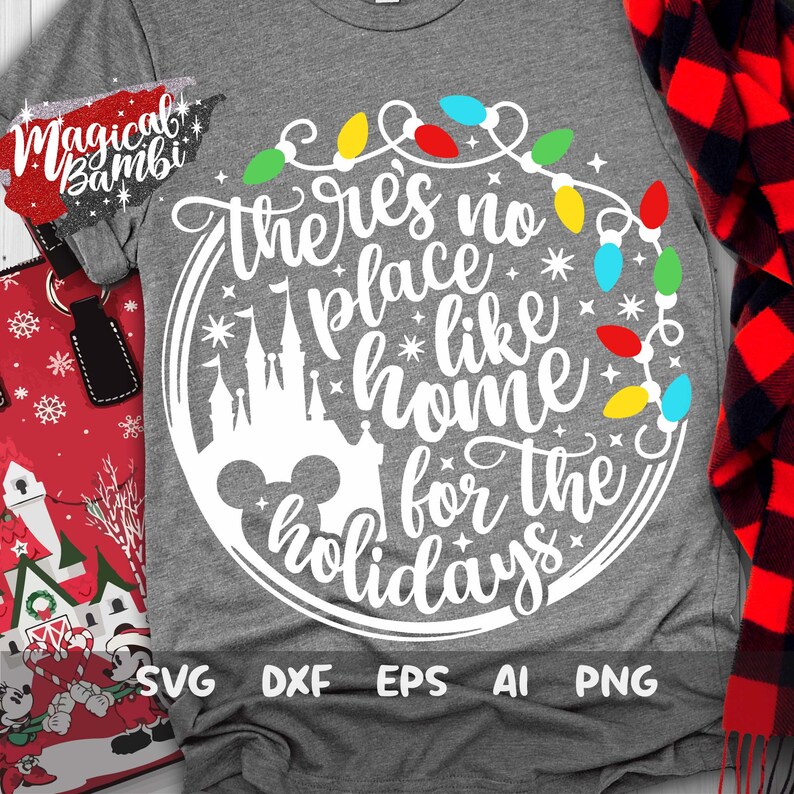 May include: A white graphic design on a gray t-shirt with the text "There's no place like home for the holidays" in a circle with a Mickey Mouse head and a silhouette of Cinderella's castle. The circle is decorated with a string of colorful Christmas lights.