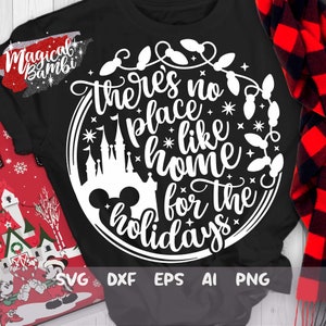 May include: A black t-shirt with a white circle design featuring a Mickey Mouse head, a silhouette of Cinderella's castle, and the text "There's no place like home for the holidays".