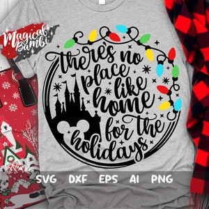 May include: A gray t-shirt with a black circle design featuring a silhouette of Cinderella's castle, Mickey Mouse ears, and the text "there's no place like home for the holidays" surrounded by a string of colorful Christmas lights.