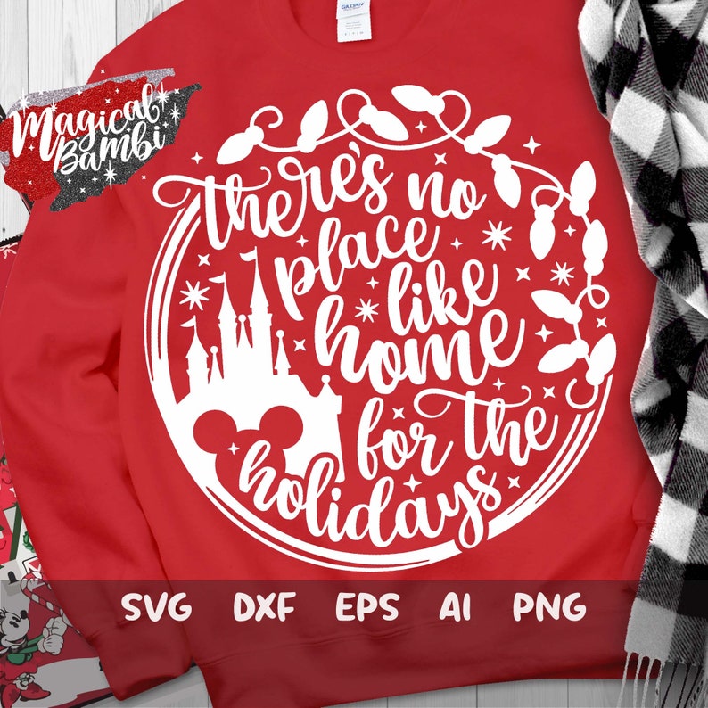 May include: White text on a red sweatshirt reads "There's no place like home for the holidays" with a Mickey Mouse head, a silhouette of Cinderella's castle, and a garland of lights around the text. The text is in a circle with a white outline.