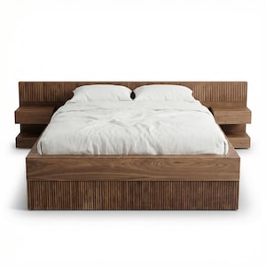 May include: A modern wooden bed frame with a headboard and two attached nightstands. The bed frame and nightstands are made of dark wood with vertical grooved detailing. The bed is made with white bedding.