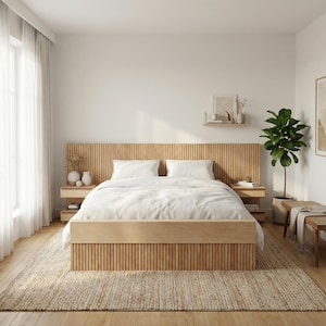 May include: A light wood bed with a slatted headboard and footboard. The bed has white bedding and pillows. Two small bedside tables are on either side. A woven rug and a potted plant complete the bedroom setting.