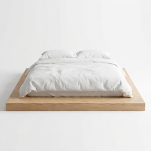 May include: A minimalist bed frame with a light wood base. The bed is covered with white bedding, including a duvet and two pillows. The design is simple and modern, suitable for a bedroom setting.
