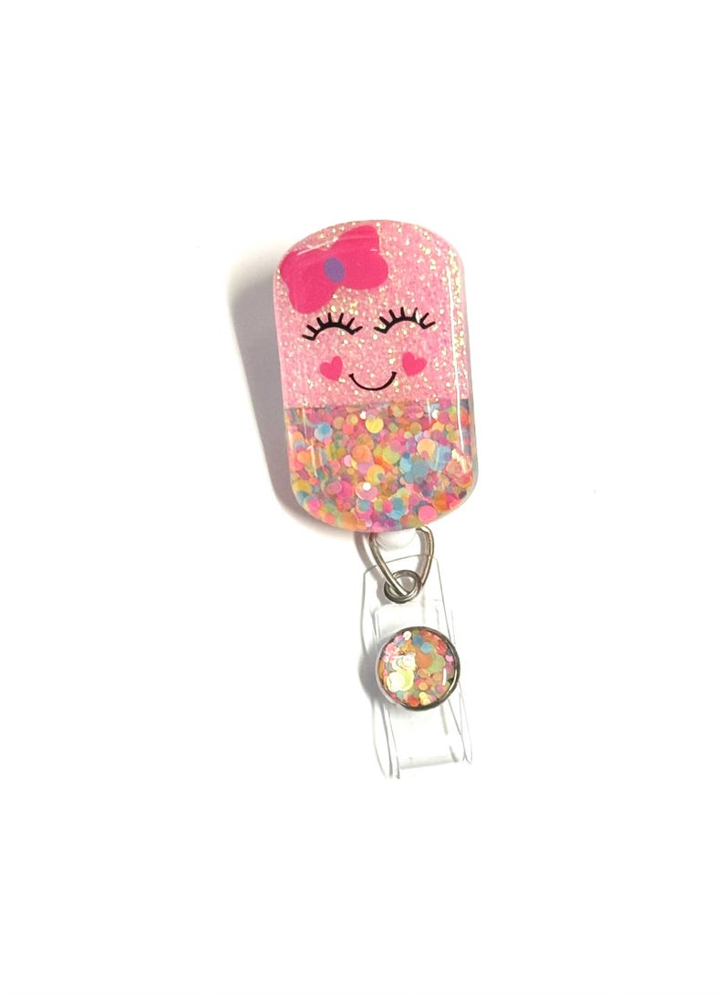 Happy Pill Badge Reel: 2”, Pink with Pink Bow, Retractable Swivel Alligator Clip, Nurse, Pharmacy image 1