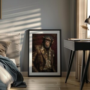 May include: Framed artwork featuring a chimpanzee in a patterned suit and open shirt. The portrait has a dark red background and is displayed in a black frame. The image is set against a gray wall with sunlight streaming through a window.