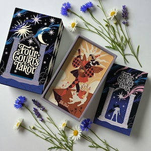 May include: A tarot card deck with a box and cards featuring illustrations. The box is black with a night sky design and the text "Four Courts Tarot". The cards depict figures and scenes. Flowers are arranged around the deck.
