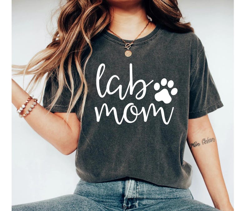 May include: A dark gray t-shirt with the text "lab mom" in white lettering and a white paw print.