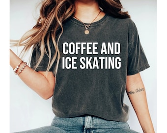 May include: A dark gray t-shirt with the text "COFFEE AND ICE SKATING" printed in white on the front.