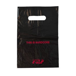 May include: A black plastic shopping bag with a die-cut handle. The bag features the red text THIS IS HARDCORE printed in the centre and the word PULP printed in red at the bottom. The material has a slightly crinkled and reflective surface.