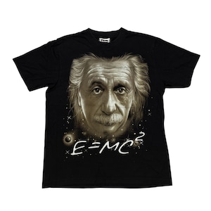 May include: Black t-shirt featuring a sepia-toned portrait of Albert Einstein with his signature mustache and hair. The equation E=MC² is written in white below the portrait, set against a starry background.