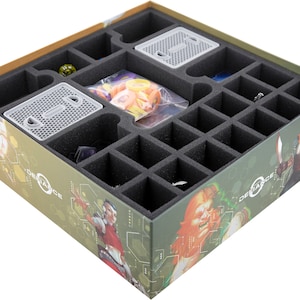 May include: A foam insert for a board game box, with compartments for storing game pieces and cards. The insert is made of black foam and has a green and brown printed design with the word "Defiance" on it.