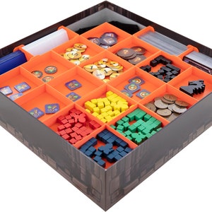 May include: Orange and black game organiser insert with compartments for various game pieces, including tokens, dice, and cards.