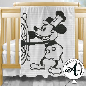 May include: Black and white crochet blanket featuring a cartoon image of Mickey Mouse in a sailor hat, holding a wheel. The blanket has the text "Annets Alphabet" in the bottom right corner.