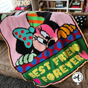 May include: A handmade crochet blanket featuring Minnie Mouse. The blanket has a pink background with a large image of Minnie Mouse in black, pink, and white. The words "BEST FRIEND FOREVER" are in yellow on a green background.