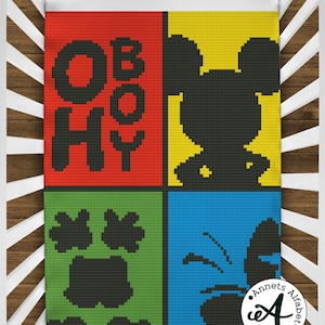 May include: A colorful crocheted baby blanket with a red, yellow, green, and blue background. The blanket features a black silhouette of Mickey Mouse, a paw print, and the words "Oh Boy".