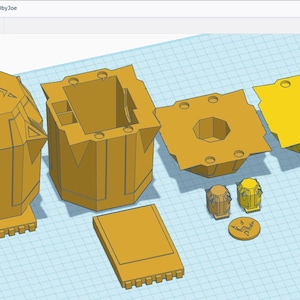 May include: A 3D printed model of a box with a lid, a base, and a decorative top. The box is made of a light brown plastic and has a geometric design. The top of the box features a stylised lightning bolt symbol.