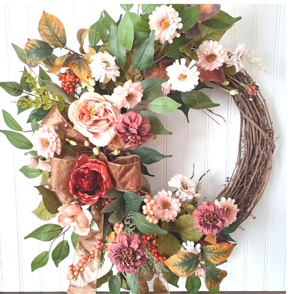 Peony wreath. Rose and daisy wreath. Year Round wreath in cinnamon and blush hues surround by ficus and finished with a copper bow.