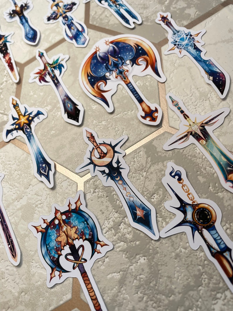 May include: A set of 10 colourful fantasy sword stickers with a galaxy theme. The stickers feature a variety of sword designs, including a crescent moon sword, a double-bladed axe, and a sword with a star at the tip. The stickers are perfect for adding a touch of fantasy to your laptop, water bottle, or planner.