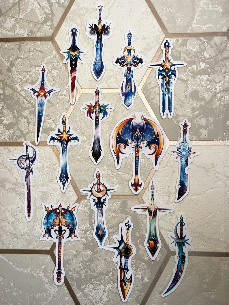 May include: A set of 15 colourful sword and axe stickers with a galaxy theme. The stickers feature a variety of designs, including swords with stars, moons, and planets. The stickers are perfect for adding a touch of fantasy to any surface.