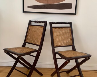 Pair of vintage folding chairs in wood and canework.