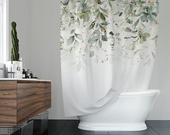 May include: White shower curtain with a watercolor design of green leaves and branches. The curtain is partially pulled back to reveal a white bathtub.