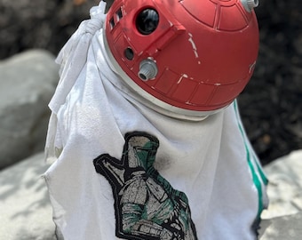 A weathered droid cape-inspired by famous bounty hunter “The Mandalorian”
