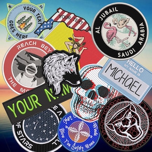 May include: A collection of embroidered patches featuring various designs including a star-shaped compass, a flag-patterned map, flamingos, a wolf head, a skull, a name tag reading HELLO MY NAME IS MICHAEL, and a panther head on a dark background.