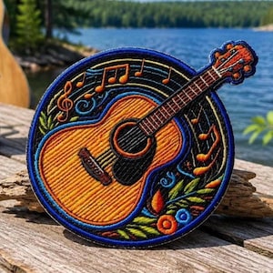 May include: Embroidered patch featuring an acoustic guitar with musical notes. The guitar is orange and brown, with a black sound hole. The patch has a blue border with colorful floral and musical accents. The background shows a lake and trees.
