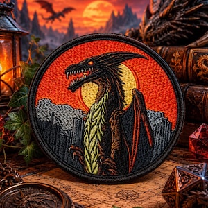 May include: Round embroidered patch depicting a black dragon with red eyes set against a sunset. The dragon has yellow and green detailing. The patch is framed by a black border, ideal for fantasy fans.