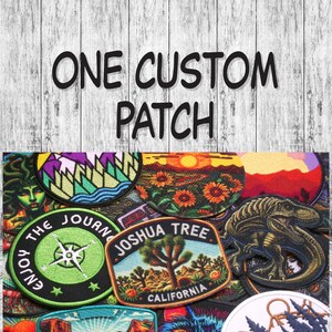 May include: A collection of colorful embroidered patches featuring various designs, including a compass, a Joshua Tree, a dinosaur, and a mountain range. The patches are arranged in a random pattern and have a variety of colors and textures. The text "ONE CUSTOM PATCH" is written in black letters on a white wooden background.