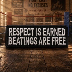 May include: A rectangular black embroidered patch with a white stitched border. The text in white capital letters reads: RESPECT IS EARNED BEATINGS ARE FREE. The patch features a dense thread texture and a clean, bold sans-serif font style.