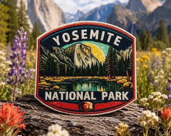 May include: Embroidered patch featuring a scenic view of Yosemite National Park. The patch displays a mountain range, lake, and trees under a yellow sun. The text "YOSEMITE NATIONAL PARK" is arched across the top and bottom in white.