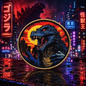 May include: Circular embroidered patch depicting Godzilla against a cityscape and a rising sun. The patch has a gold border and is set against a neon-lit urban background with Japanese text.