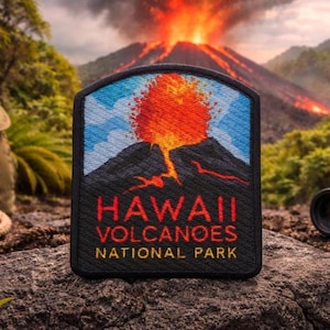 May include: A rectangular patch featuring a volcano erupting with red and orange lava against a blue sky. The patch reads "HAWAII VOLCANOES NATIONAL PARK" in red and yellow lettering. The patch is black with a black border.