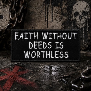 May include: A black rectangular patch with white embroidered text: "FAITH WITHOUT DEEDS IS WORTHLESS." The patch is set against a dark, textured background with a skull graphic and a chain.