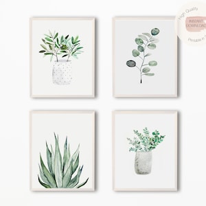 May include: Set of four watercolor prints featuring green foliage in white pots. The prints are framed in white and are arranged in a grid pattern.