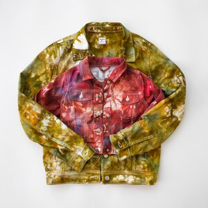 May include: Two denim jackets, one in a green and yellow tie-dye pattern and the other in a red and purple tie-dye pattern.