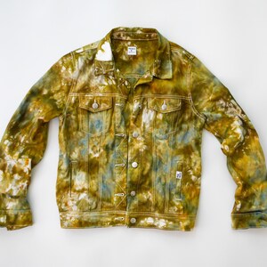 May include: A tie-dye denim jacket in shades of green, yellow, and blue. The jacket has a classic design with a button-up front and two pockets.