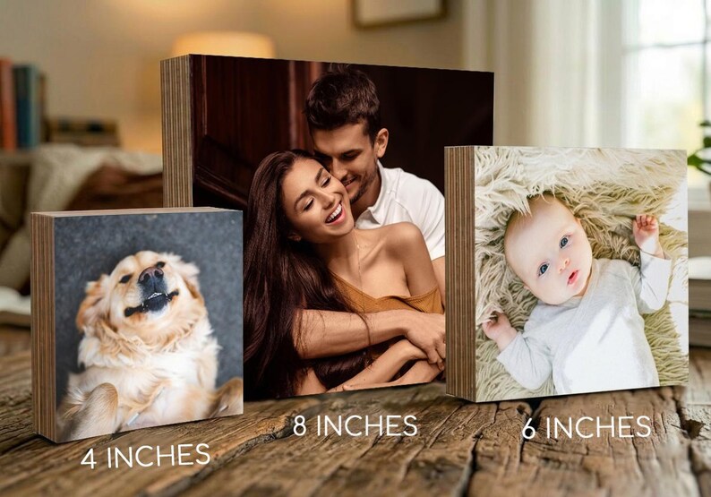 three different sizes of wooden blocks, each containing a different type of photo: a close-up of a dog, a couple embracing, and a baby lying down.
